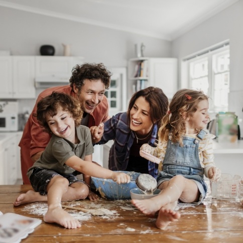 Family of four laughing together