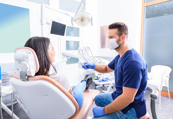 A dentist talking with his patient about direct bonding