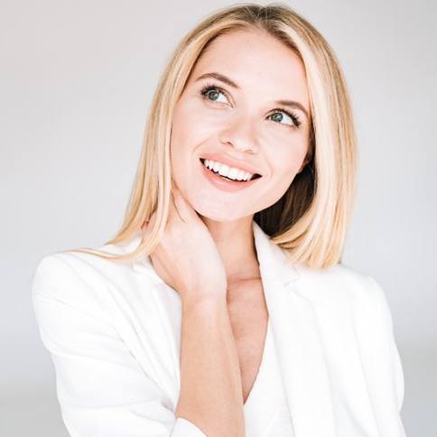 a woman smiling after paying the cost of cosmetic dentistry