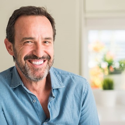 a man smiling after undergoing cosmetic dentistry