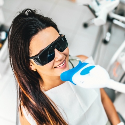 Woman receiving professional teeth whitening