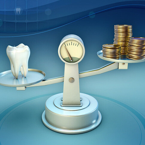 Tooth and coins on a balance scale