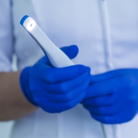 Dentist holding an intraoral camera