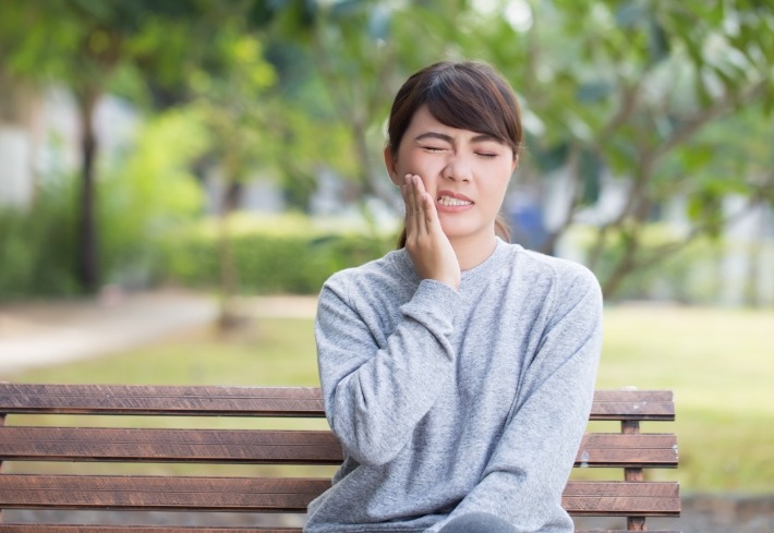 Woman in pain before emergency dentistry