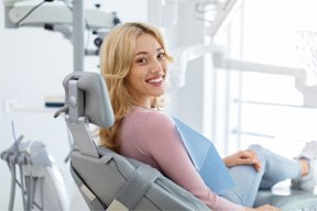 Woman smiling while sitting in treatment chair