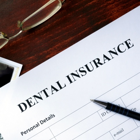 Dental insurance forms and pen