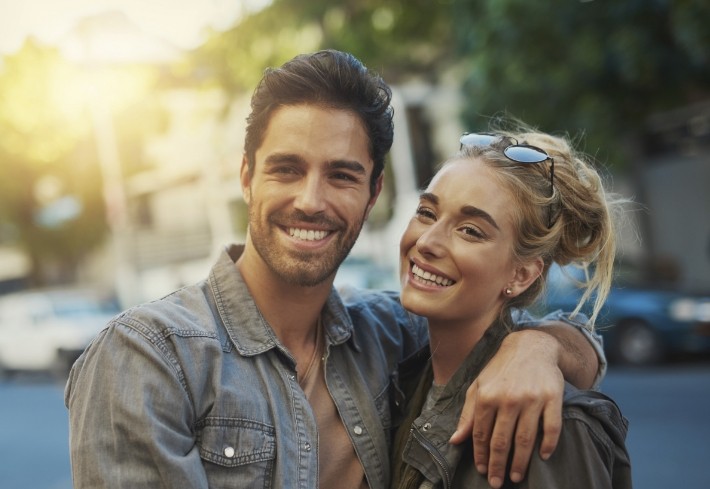 Man and woman with healthy smiles thanks to comprehensive dental services