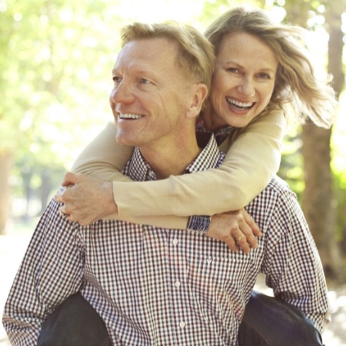 Man and woman with healthy smiles thanks to preventive dentistry