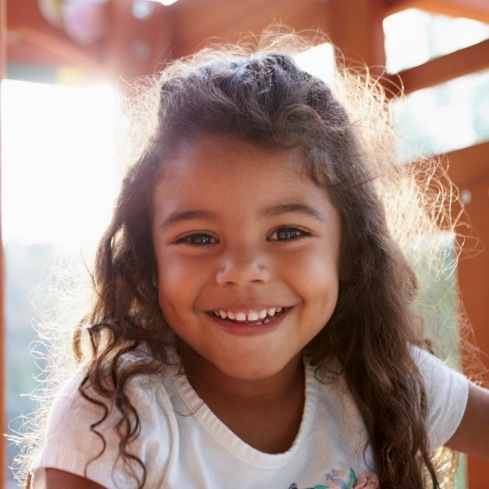 Young girl smiling after visiting the children's dentist