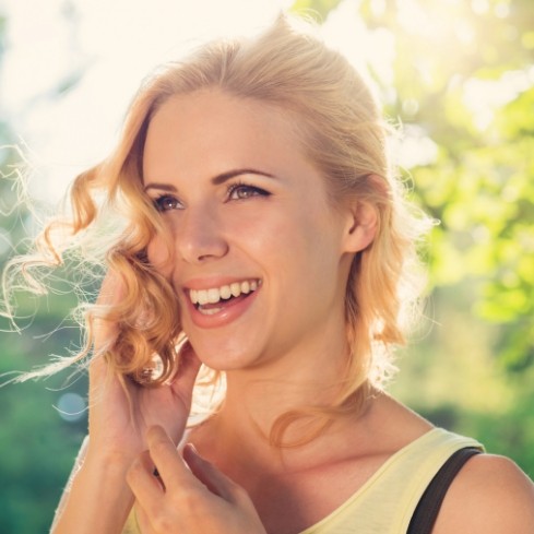 Woman with healthy smile after emergency dentistry