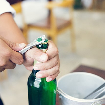 Man using bottle cap opener