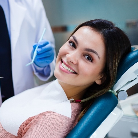 Woman smiling during preventive dentistry checkup and teeth cleaning visit