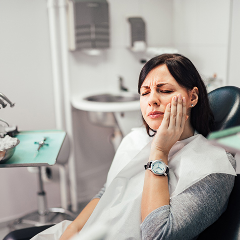 Woman with toothache at dentist's office 