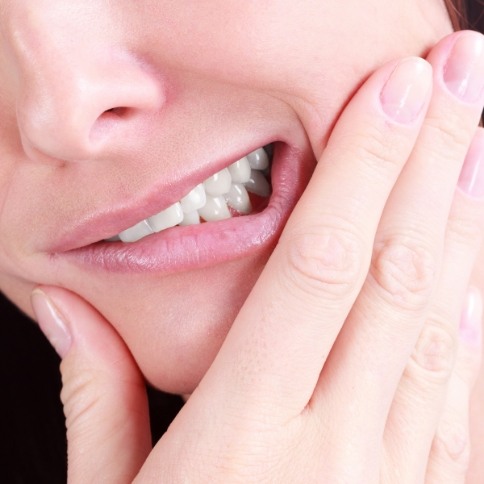 Closeup of dental patient in pain before tooth extractions