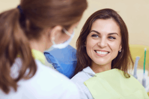 a patient chatting with their dentist about teeth whitening
